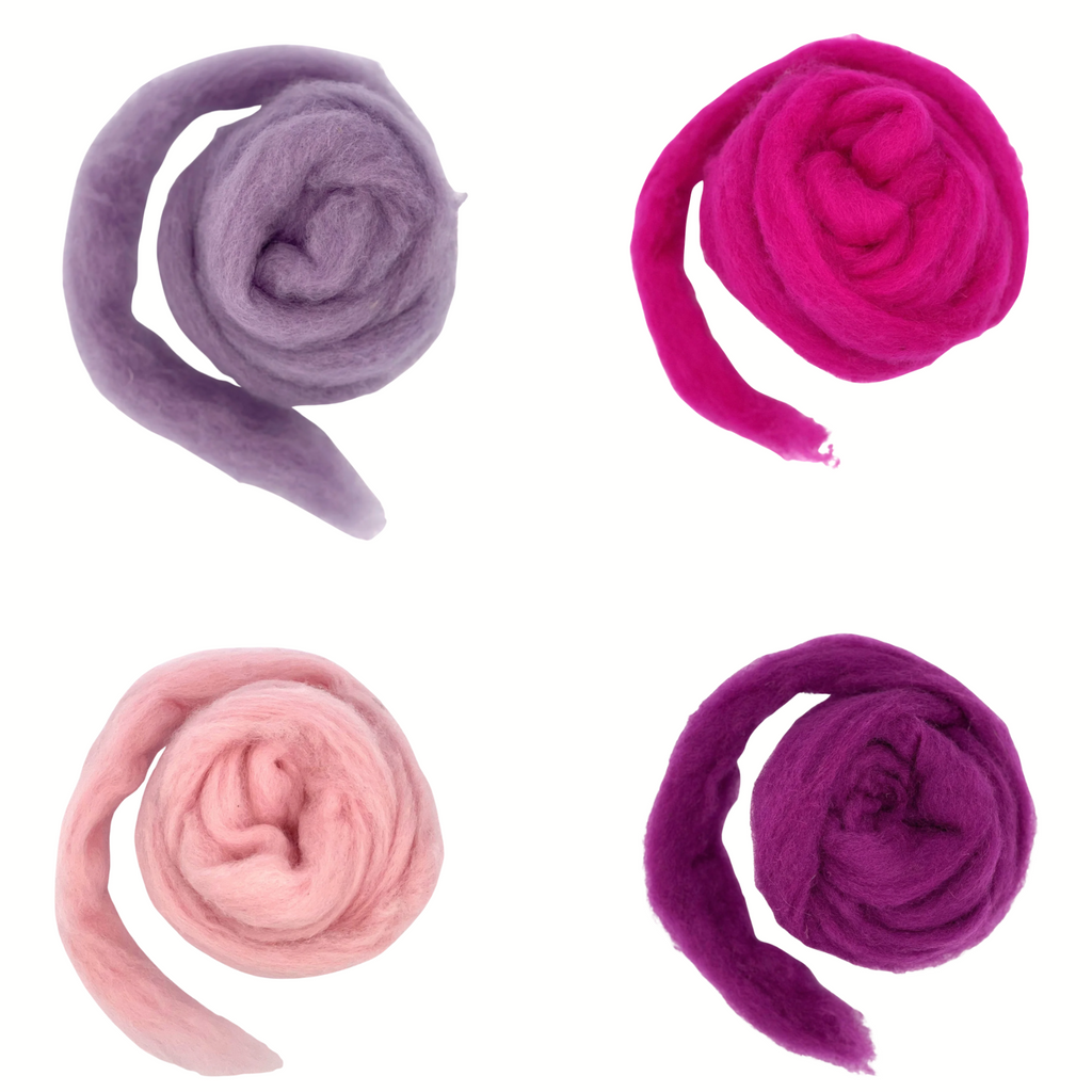 Four balls of pink and purple wool on a white background