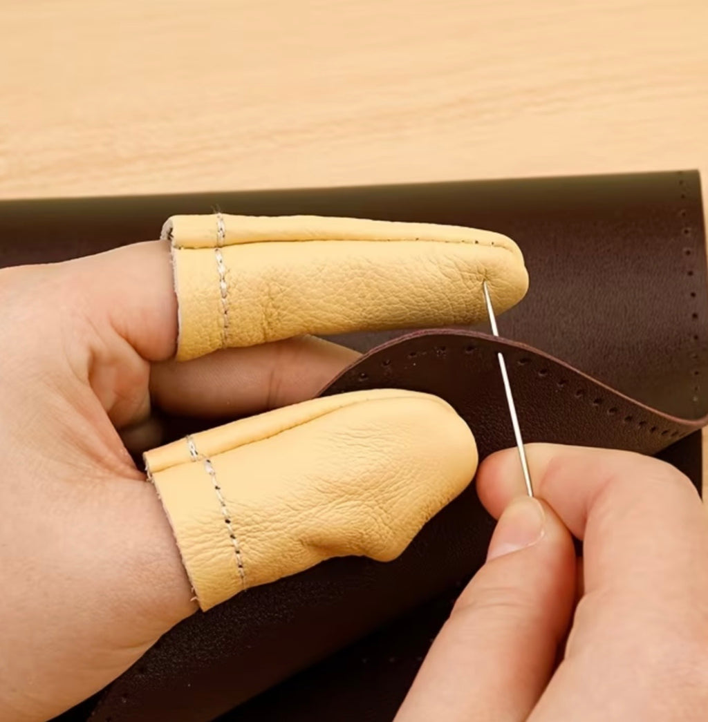 Hand sewing leather with a needle and brown leather material