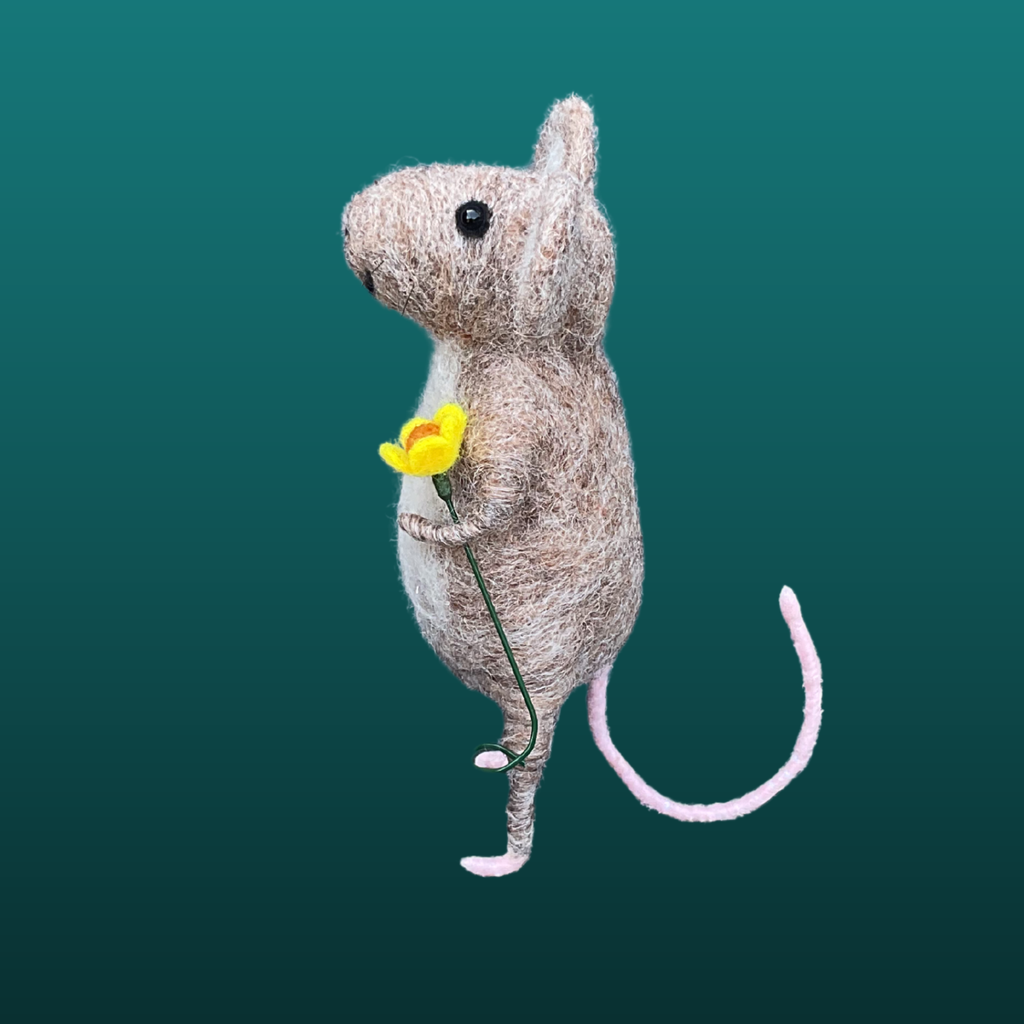 Needle felt mouse holding flower side view